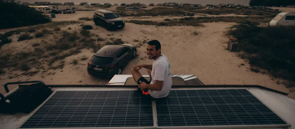 Solar canopy for beach trips set up on a sunny coastline, providing shade and charging power