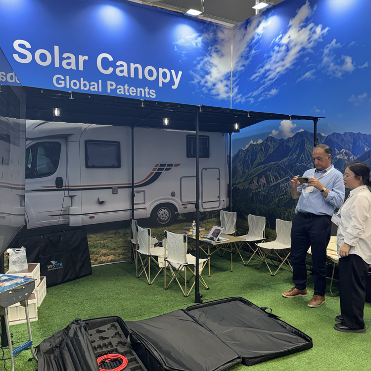 Wistek team demonstrating the structural features and off-grid power capabilities of the Solar Canopy to visitors.